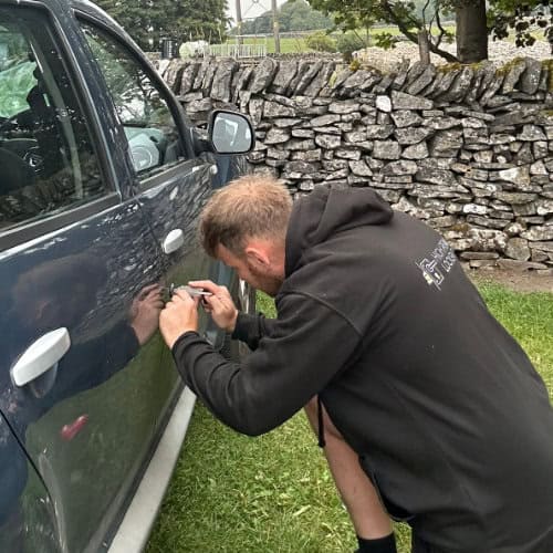 James from High Peak Locksmiths gaining access to a car at a camping site just outside Buxton