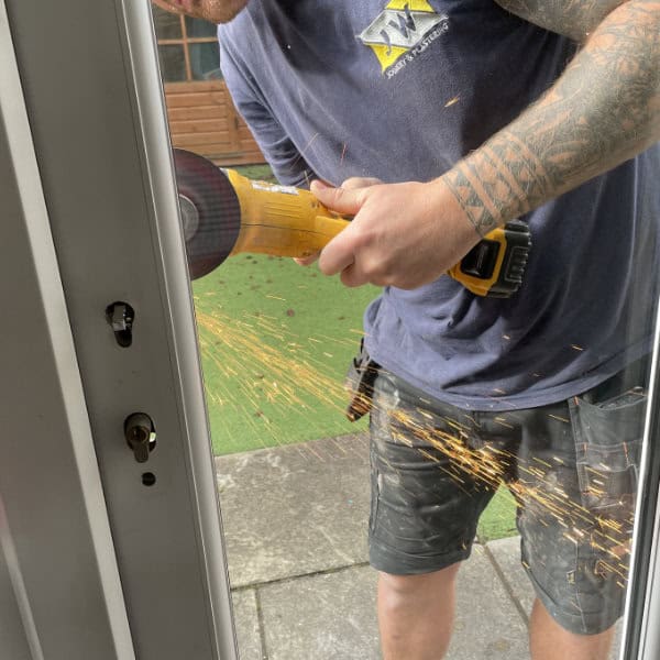 James at High Peak Locksmith adjusting the fitting on a back door lock replacement