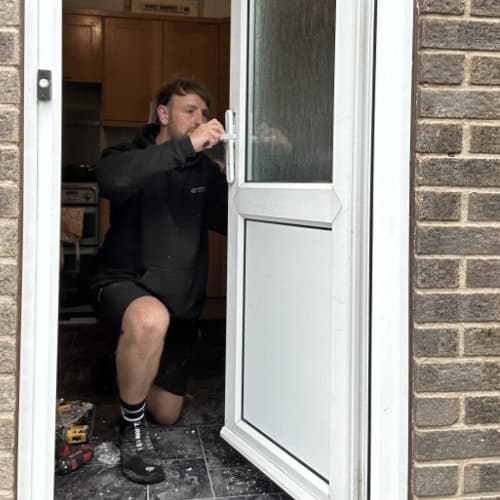 James from High Peak Locksmith replacing a lock on a UPVC door.